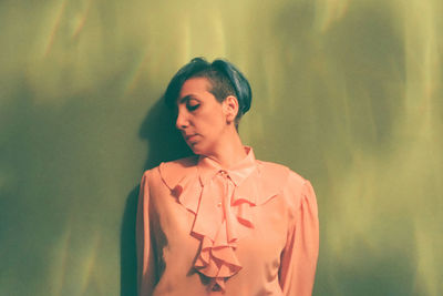 Mature woman leaning on wall