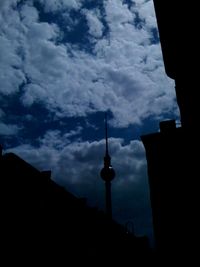 Low angle view of tower against cloudy sky