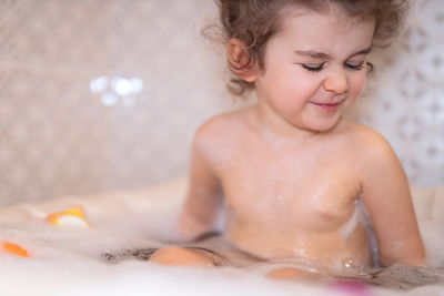 Cute girl bathing in bathroom