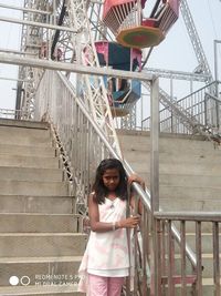 Portrait of woman standing on staircase