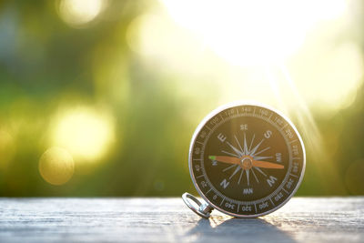 Close-up of compass on table