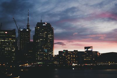 Illuminated buildings against sky at night