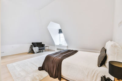 Chairs and table on bed against wall at home