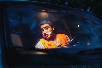 Portrait of woman sitting in car