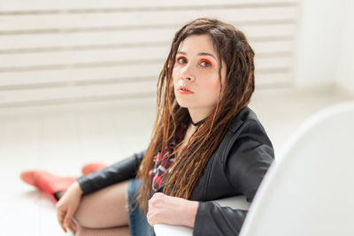 Portrait of woman sitting on floor