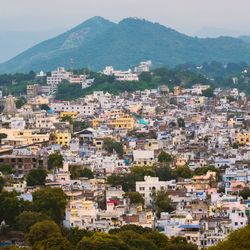 High angle view of townscape and mountains against sky