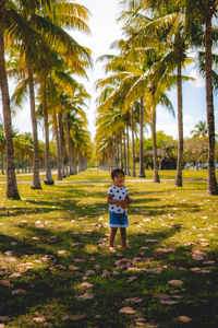 Rear view of boy standing at park