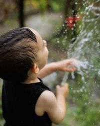 Rear view of boy in water