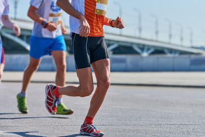 Marathon runners on city road. running competition. street sprinting outdoor. healthy lifestyle