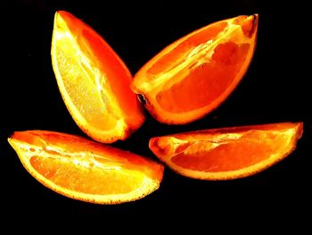 Close-up of orange fruit against black background