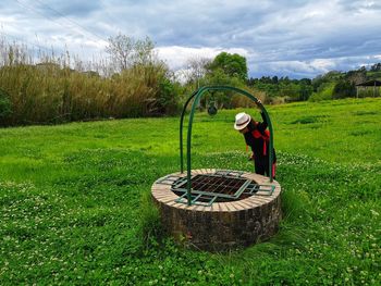 Girl around the water well