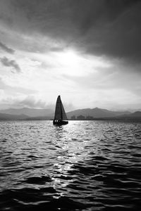 Sailboat sailing on sea against sky