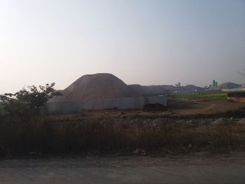 Built structure on field against clear sky