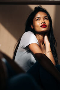 Portrait of young woman sitting at home