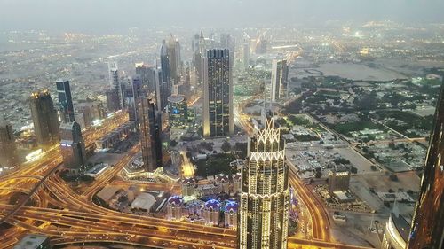 Aerial view of city lit up at night