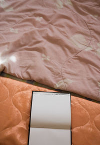 Close-up of laptop on bed