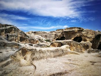 Rock formations on landscape against sky