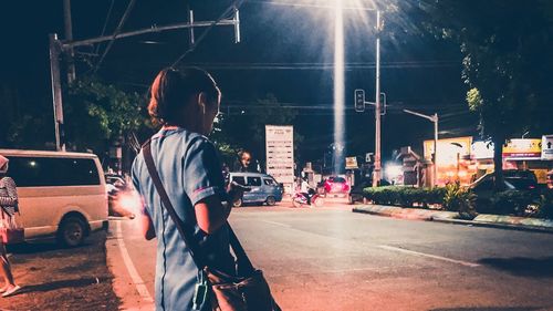 Vehicles on road in city at night