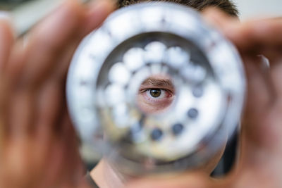 Businessman looking through manufacturing equipment