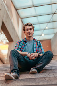 Portrait of young man sitting outdoors