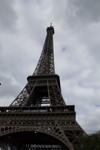 Low angle view of tower against cloudy sky