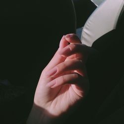 Cropped hand of woman in darkroom