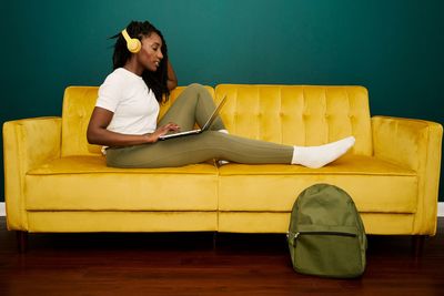 Black styled student woman having a videoconference at the coach