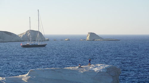 Sailboat on sea against clear sky