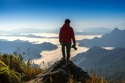 Man standing on mountain against sky