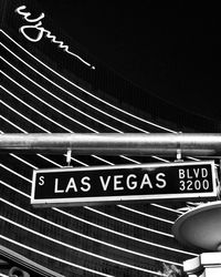 Low angle view of information sign at night