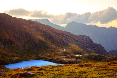 Sunrise on fagaras mountain ridges over the capra glacier lake, romania