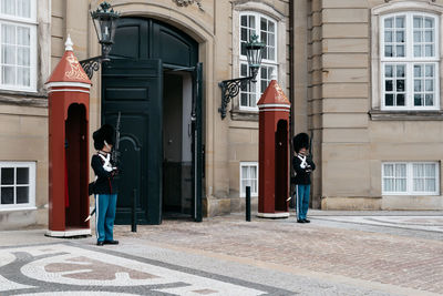 Army soldiers standing in front of built structure