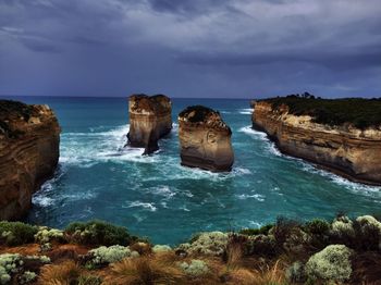 Rock formation on sea against sky