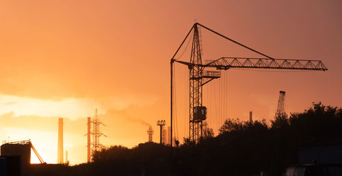 Plant on sunrise, industrial background. factory with crane