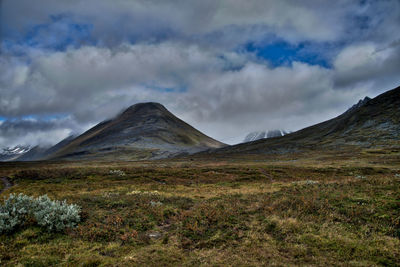 Scenic view of mountains against cloudy sky