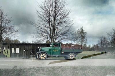 Vintage car on field against sky