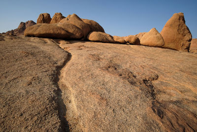 Rock formations on landscape against sky