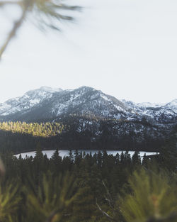 Scenic view of lake by mountains against sky