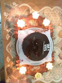 High angle view of lit candles on birthday cake