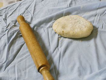 Close-up of dough and rolling pin on table