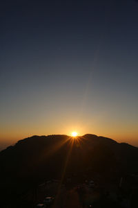 Scenic view of silhouette mountains against sky during sunset