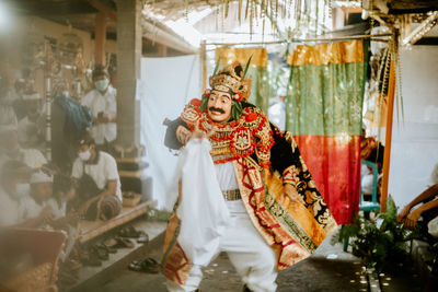 Man wearing costume dancing outdoors