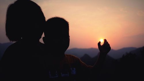 Silhouette of woman at sunset