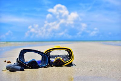 Close-up of sunglasses on beach