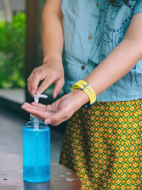 Midsection of woman holding drink