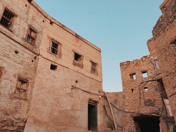 Low angle view of old building against clear sky