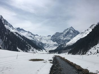 Scenic view of snowcapped mountains against sky