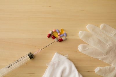 Close-up of bouquet with pills and surgical gloves on table