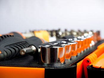 Close-up of drill bits against white background