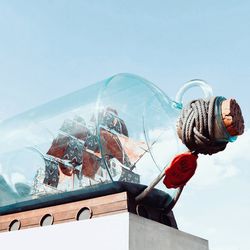 Reflection of man holding umbrella on sea against sky